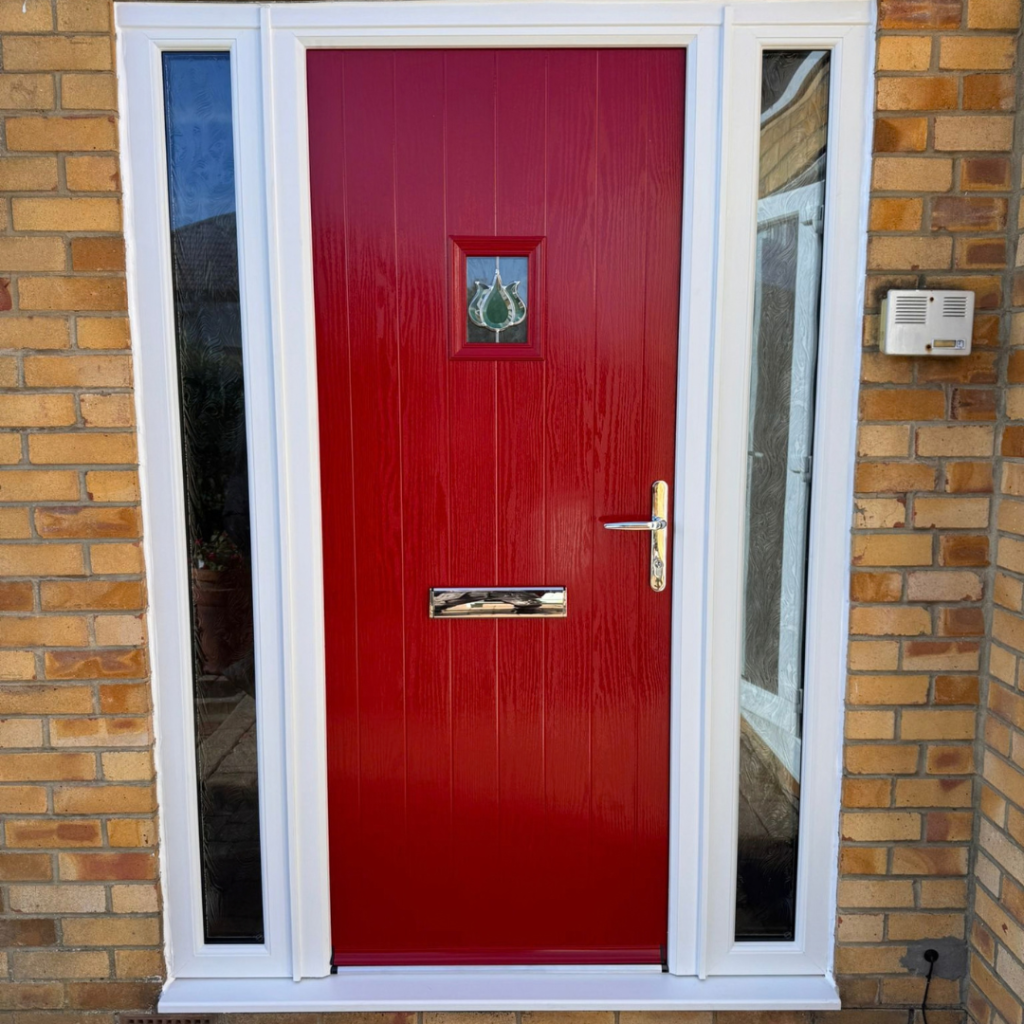 red composite door with glass panels either side